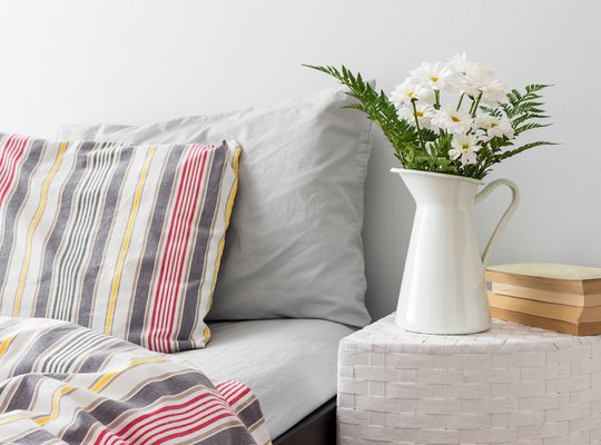 white-flowers-and-books-on-a-bedside-table
